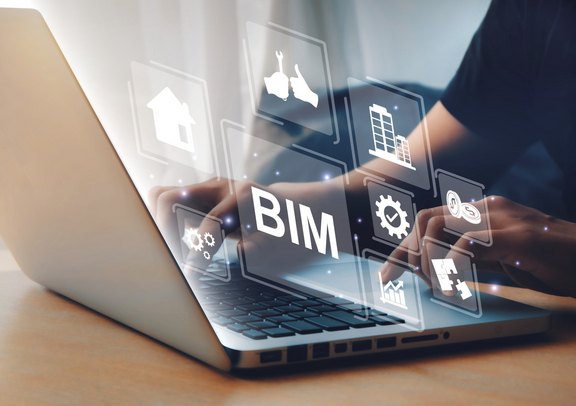 BIM-Elementkataloge Person von einem Laptop aus diesem Icons zum Thema Building Information Modeling fliegen